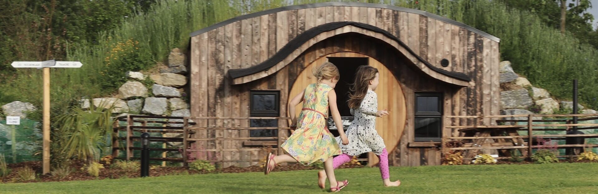 Glamping Under The Stars Girls running past Hobbit House Co Laois TI7SIR